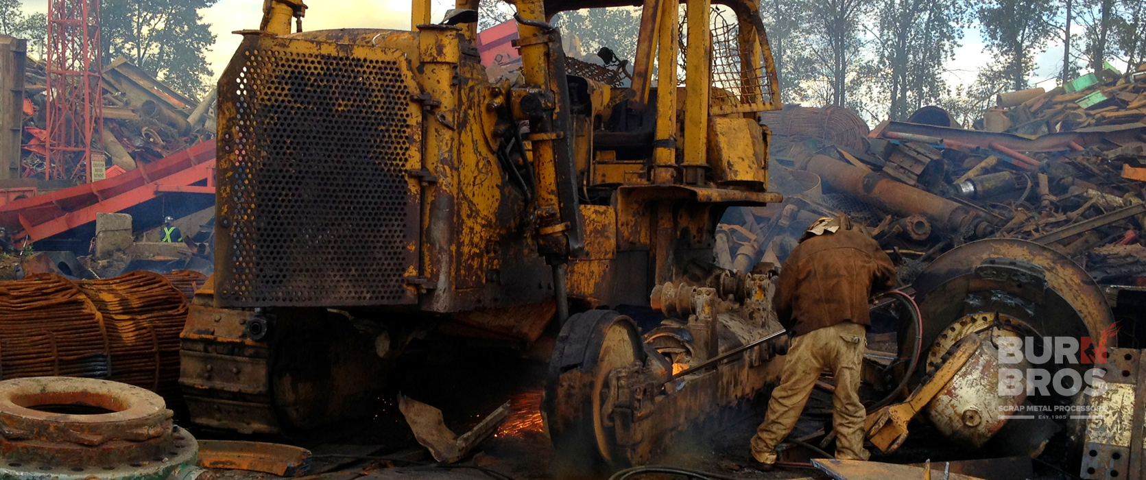 Picture of torchman cutting bulldozer into pieces